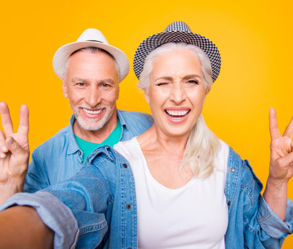 Two Seniors flashing peace signs